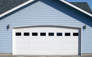 Garage of a blue house with PVC siding 