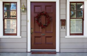 Burgundy front doors and two windows